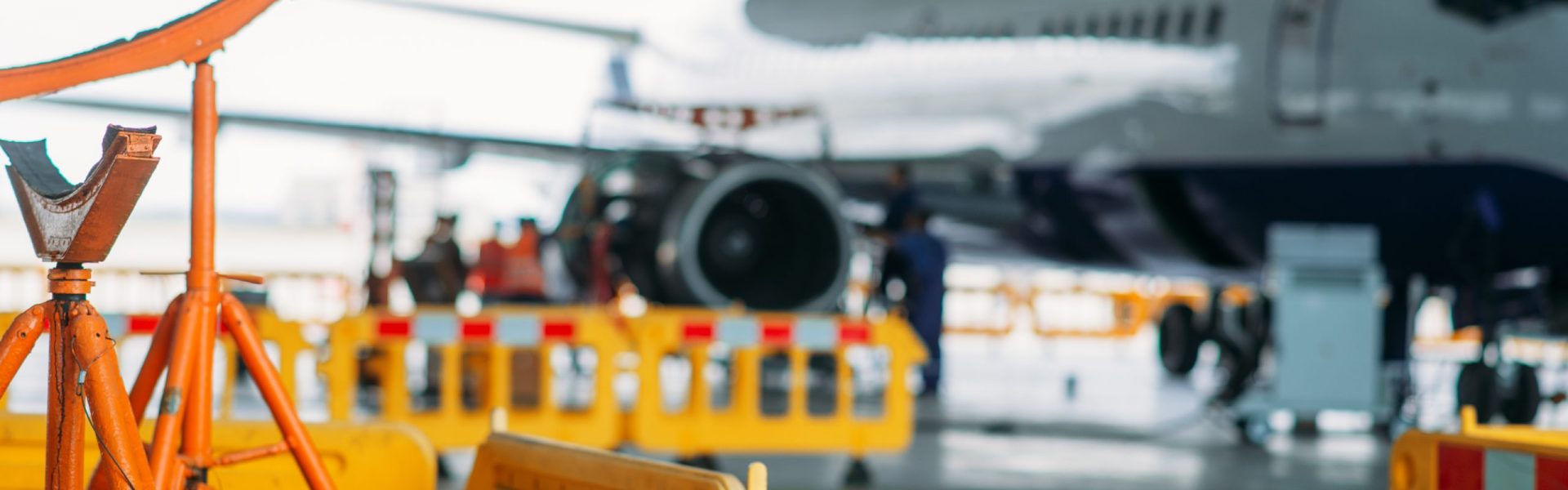 Aircraft on repairing in hangar, plane on inspection before flight. Passenger jet airplane engine maintenance, air transportation safety