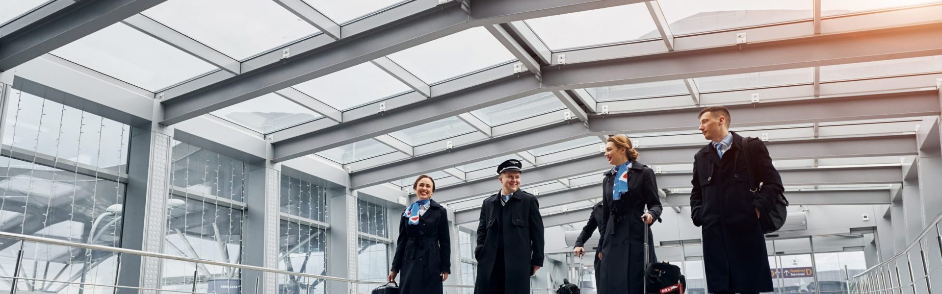View from below. Airplane crew in uniform is going to the work together.