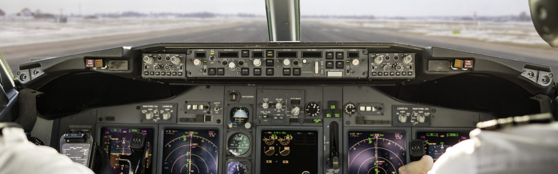 Captain is pulling an aircraft throttle, while first officer is piloting and taking off. Pilots are sitting in Boeing 737-800.