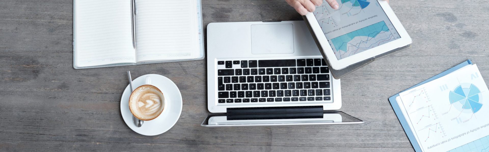 Cropped image of entrepreneur analyzing annual statistics on digital tablet, view from above